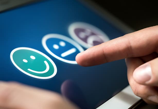 Survey, poll or questionnaire for user experience or customer satisfaction research. Quality control and feedback concept. Man choosing his opinion with smiley faces on touch screen.